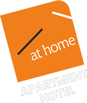 White logo of At Home Serviced Apartments